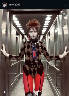 a woman dressed up as harley in a hallway with her hands out to the side