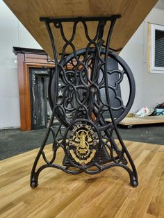 a wooden table with metal legs and a clock on it