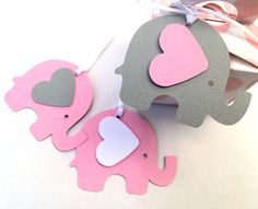 two pink and gray elephants with hearts on them