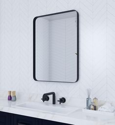 a bathroom with two sinks and a large mirror on the wall above it, along with other items