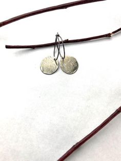 One of my personal favorites, these are my "go to" earrings! My leftover silver gets melted and hammered into these lightweight disks that have subtle character with a soft silver patina. A classic look, these earrings will always be in style no matter where you go! Hanging from a sterling silver wire hoop, they measure about 1 1/4" from top to bottom. Free shipping in the USA! Shipped in a gift box ready for giving! Due to the custom nature of these earrings, no two are alike. Slight variations Small Hoop Hammered Silver Earrings, Silver Stamped Earrings For Everyday, Everyday Silver Stamped Earrings, Silver Hammered Hoop Earrings For Everyday, Everyday Silver Hammered Hoop Earrings, Sterling Silver Soldered Hoop Earrings, Hammered Sterling Silver Round Disc Earrings, Silver Round Disc Earrings For Everyday Wear, Everyday Silver Round Disc Earrings