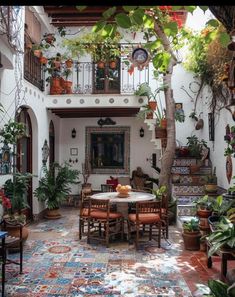 an outdoor dining area with potted plants on the walls and tables in the middle