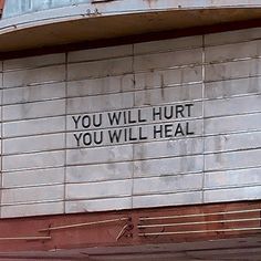 a sign on the side of a building that says you will hurt you will heal