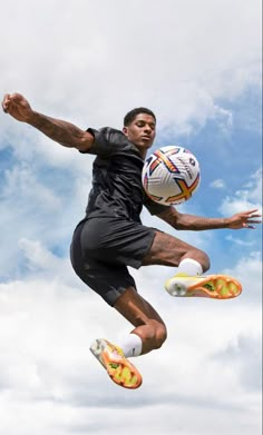 a man jumping in the air with a soccer ball