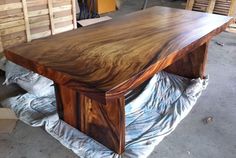 a large wooden table sitting on top of a pile of wood