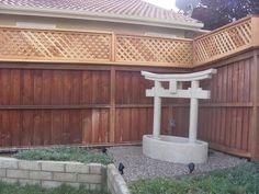 a wooden fence with a white statue in the middle