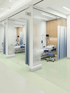 an empty hospital room with beds and chairs