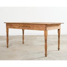 an old wooden table with one drawer on the top and two legs at the bottom