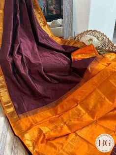 Indulge in the luxury of our Kanjeevaram silk cotton handloom saree. Experience the elegance of Maroon Orange and the intricate craftsmanship of handloom weaving. This saree is a timeless fusion of tradition and style that will make you stand out in any occasion. Kanjeevaram silk cotton handloom saree - Maroon Orange Saree comes with a blouse piece. Fall and pico done. Fully stitched blouse shown in pictures is optional and can be purchased seperately from our blouses and croptops section. For saree video please connect with us on whatsapp @469-937-0606 Ready to be shipped in USA from San Diego, California. All pictures are original pictures. Colors may slightly vary due to pic resolution. Diwali Cotton Silk Pre-draped Saree With Border, Cotton Silk Saree With Border In Traditional Drape, Cotton Silk Saree With Traditional Drape And Border, Traditional Drape Cotton Silk Saree With Border, Handloom Cotton Silk Pre-draped Saree, Anarkali Cotton Silk Saree With Border, Cotton Silk Saree With Border, Cotton Silk Pre-draped Saree With Border For Puja, Cotton Silk Pre-draped Saree With Border