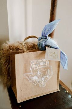 a brown bag sitting on top of a wooden chair next to a stuffed animal toy