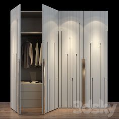 an open closet with clothes hanging on the wall