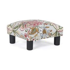 a foot stool with floral fabric and black legs