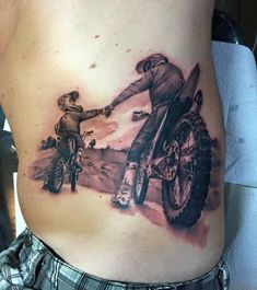 a woman with a tattoo on her stomach holding the hand of a man riding a motorcycle