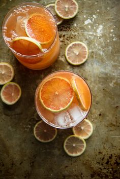 two glasses filled with orange juice and garnished with lemon slices