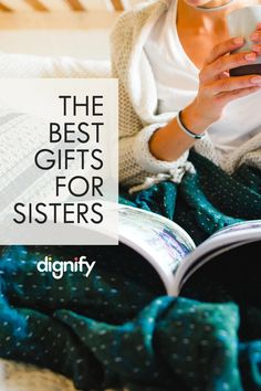 a woman sitting on her bed reading a book and holding a remote control in her hand