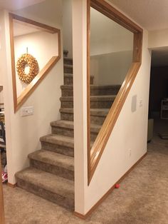 an empty room with carpeted stairs and a mirror on the wall above it,