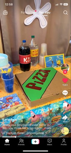 an open box sitting on top of a table next to bottles of soda and other items