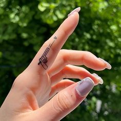 a woman's hand with a small tattoo on it