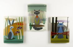 three glass magnets with animals painted on them