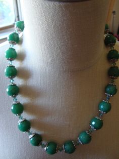 Gorgeous Czech Glass Bead Necklace that is 20 inches long.  Very substantial, artisan crafted from a Craft Faire decades ago.   The beads are approximately 13 mm, faceted round beads.  They look very much like real Aventurine.  Each bead sits between two flower shaped end caps with a green crystal bicone bead in between each.   Beautiful silver ornate toggle clasp (looks like sterling). Faceted Bead Necklace, Hallmark Christmas Ornaments, Green Beads, Green Crystal, Glass Bead Necklace, Artisan Craft, Toggle Clasp, Green Bead, Green Crystals