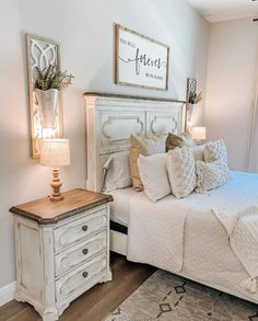 a white bed sitting in a bedroom next to a window