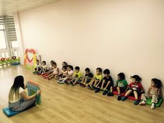 there are many children sitting on the floor