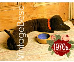 a stuffed animal is laying on the floor next to a blue bowl and wooden door