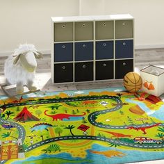 a child's play area with toys, bookshelves and rugs on the floor