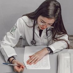 a female doctor writing on a piece of paper