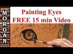 a person is painting eyes with paintbrushes