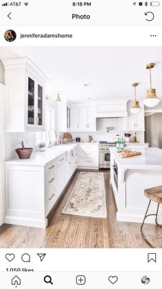 a kitchen with white cabinets and wood floors is featured in the instagram post on instagram com