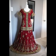 Brand New, Never Worn! Classic Red Bridal Lengha, Top, And Heavy Dupatta. Adorned With Pearls All Over. You Can Wear This For A Nikkah Event And Then Use The Beautiful Dupatta Again With Simpler Outfits. Will Look Amazing Paired With A Dark Green Or White Outfit! Serious Buyers Only. I Will Be Paying Extra To Ship Due To The Weight Of The Outfit So Please Keep That In Mind. Elegant Red Salwar Kameez With Cutdana, Elegant Red Sharara With Dori Work, Elegant Red Sharara With Pallu, Red Salwar Kameez With Traditional Drape For Reception, Elegant Red Sharara With Traditional Drape, Elegant Red Saree With Dabka Work, Elegant Red Sharara For Festivals, Elegant Red Saree Set With Pallu, Elegant Red Lehenga With Dabka Work