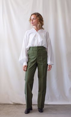 "These 80s army high waist pants feature the following: Straight slim leg, zipper fly, belt loops, two front flat pockets, two back flap pockets. PLEASE READ MEASUREMENTS CAREFULLY. These are best for petite figures. Maker: Military Made in the USA Material: 100% Cotton CONDITION: Excellent, These are all deadstock and have never been worn. Measurements: 25\" Waist / 13\" Rise / 34-35\" Hips NARROW / 11.5\" Thigh flat / 9\" Leg Opening / 30.5\" Inseam Ellie is 5'3\" and wears 0-00 in modern jean High Waist Khaki Military Pants, High Waist Military Khaki Pants, Military Style High Waist Khaki Pants, High Waist Military Pants In Khaki, Military High Waist Khaki Pants, Khaki High-waisted Pants With Belt Loops, High Waist Military Style Cotton Bottoms, High Waist Military Cargo Pants, High-waisted Military Cargo Pants