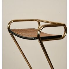 a gold metal chair with a black seat