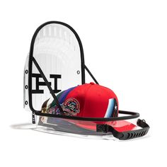 a baseball cap and headgear sitting on top of a racket