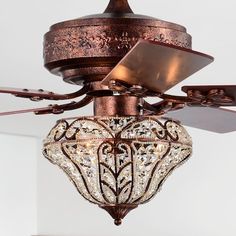 a chandelier hanging from a ceiling fan in a room with white walls and flooring