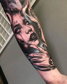 a man's arm with an image of a woman and two faces on it