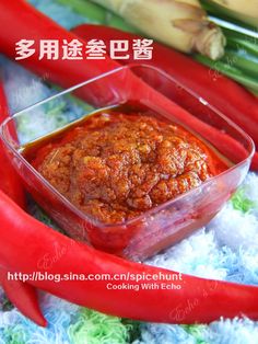 there is a small container with food in it on the table next to some vegetables