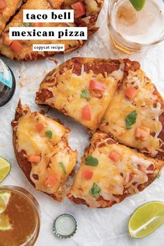 taco bell mexican pizza is cut into four pieces and served with lime wedges