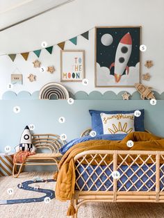 a bedroom with blue walls and pictures on the wall, including a rocket ship bed