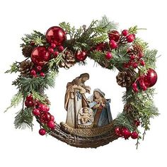 christmas wreath with nativity scene in center surrounded by pine cones, red berries and evergreens