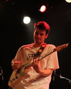 a man playing an electric guitar on stage