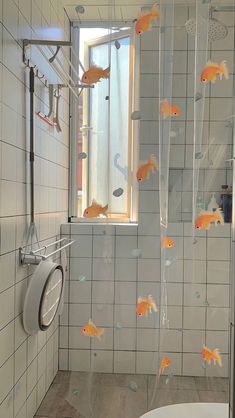 a bathroom with goldfish in the shower