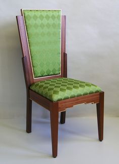 a green chair sitting on top of a white floor