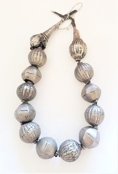 "Beautiful Large and heavy coin silver beads made by the Harrar people of Ethiopia. Very impressive indeed! The beads are handmade of a good silver alloy (though below sterling of course). The beads are hollow and filled with clay, resin or a similar substance to stabilize them. The necklace is traditionally strung on thread which is simply knotted at the back, allowing to be worn a bit longer or shorter. Of course the necklace could also be restrung. Collectors, however, may prefer it in its or Festival Silver Beaded Temple Necklace, Silver Beaded Temple Necklace For Festivals, Traditional Silver Beaded Temple Necklace, Handmade Silver Temple Necklace With Round Beads, Handmade Silver Traditional Beaded Necklaces, Traditional Handmade Silver Beaded Necklaces, Silver Temple Necklace With Round Beads As Gift, Handmade Silver Beaded Traditional Necklace, Handmade Traditional Silver Beaded Necklaces