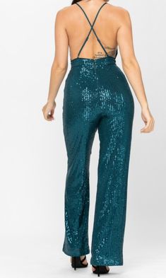 All over sequin, sleeveless, bodycon jumpsuit with a v-neckline, spaghetti straps, and a wide leg 100% POLYESTER Sequin Jumpsuits And Rompers For Formal Summer Events, Summer Formal Sequined Jumpsuits And Rompers, Formal Sequined Jumpsuits And Rompers For Summer, Party Strapless Stretch Jumpsuit With Wide Leg, Party Strapless Stretch Wide Leg Jumpsuit, Party Strapless Wide Leg Stretch Jumpsuit, Party Wide Leg Stretch Strapless Jumpsuit, Green Sequined Party Pants, Green Sequined Party Bottoms