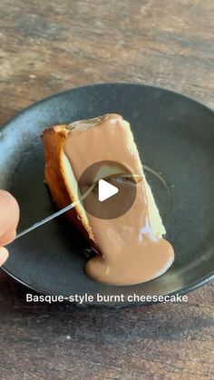 someone is cutting into a piece of cheesecake with chocolate sauce on the top and bottom