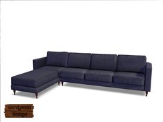 a blue sectional couch sitting on top of a wooden floor next to a white wall