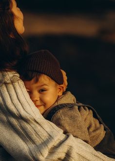 a woman holding a small child in her arms