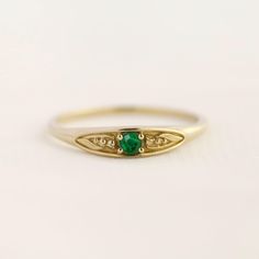 May birth ring This ring will be a very meaningful piece for those born in May. May's birthstone and birth flower are emerald and lily of the valley. Vivid green emerald and delicately carved lily of the valley will shine and bloom forever. This dainty and slim signet ring is comfortable to wear all the time. This piece will be perfect gift for both to others and yourself.   * Detail * Material : 14K solid gold, 18K solid gold, 925 sterling silver Color : Yellow gold, White gold or Rose gold(925